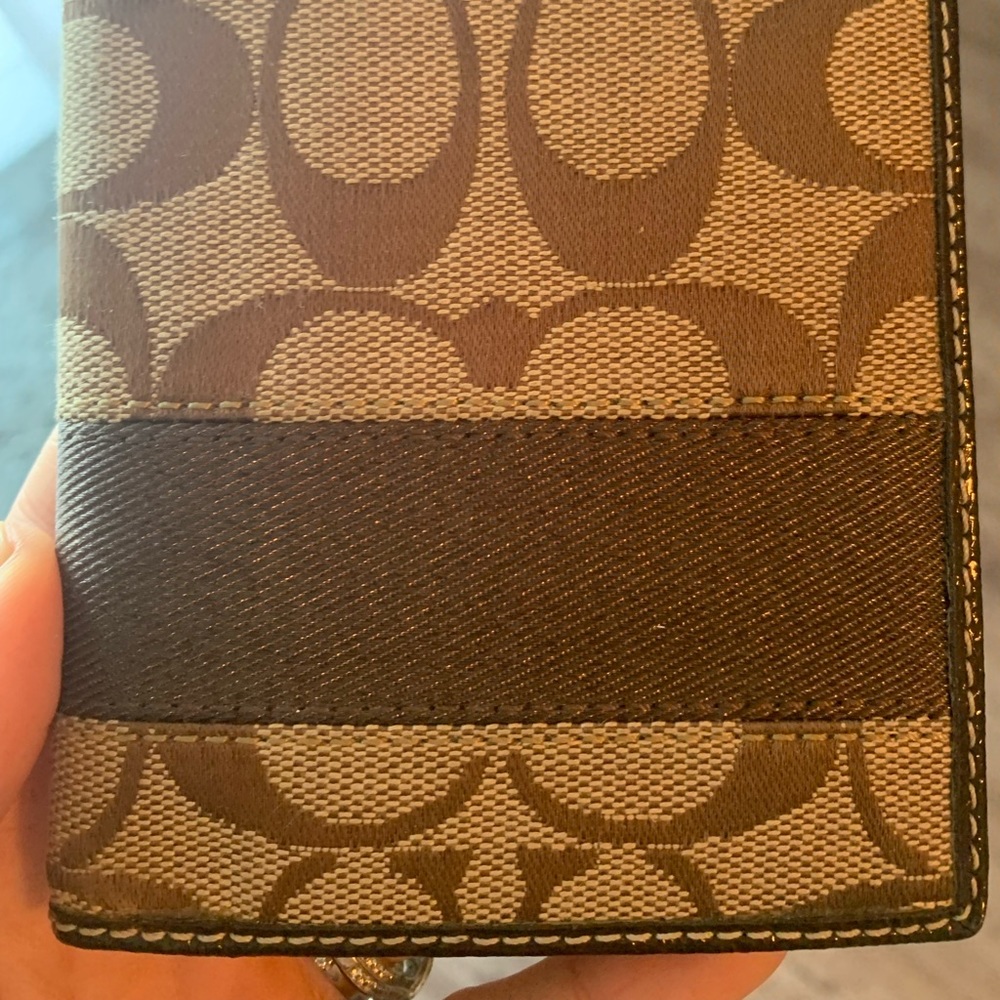 Brown coach passport cover